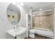 Bathroom featuring a pedestal sink, toilet, and tub/shower combination with glass doors at 1705 Gaylord St # 201, Denver, CO 80206