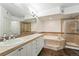 Bright bathroom features a double sink vanity, soaking tub with tile surround and a glass-enclosed shower at 1705 Gaylord St # 201, Denver, CO 80206