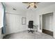 Bedroom featuring neutral carpet, ceiling fan, closet, and adjacent frosted-glass doorway at 1705 Gaylord St # 201, Denver, CO 80206