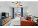 Bedroom with balcony access, ceiling fan, and comfortable decor at 1705 Gaylord St # 201, Denver, CO 80206