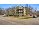 Charming multi-story condo building featuring balconies, brick accents, and lush landscaping at 1705 Gaylord St # 201, Denver, CO 80206