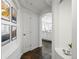 Hallway with slate floors, alcoves, and white walls with decor; kitchen view at 1705 Gaylord St # 201, Denver, CO 80206