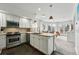 Open-concept kitchen with modern appliances, breakfast bar, and view to the living area at 1705 Gaylord St # 201, Denver, CO 80206