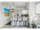 Bright kitchen with bar seating, modern lighting and stainless steel appliances at 1705 Gaylord St # 201, Denver, CO 80206