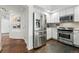 Kitchen with stainless steel appliances, white cabinets and decorative tile flooring at 1705 Gaylord St # 201, Denver, CO 80206