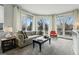 Bright living room with large windows, balcony access, and comfortable seating at 1705 Gaylord St # 201, Denver, CO 80206