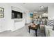 Open concept living room showcasing a breakfast bar and TV built-ins at 1705 Gaylord St # 201, Denver, CO 80206