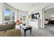 Inviting living area with large windows, balcony access, and cozy furnishings at 1705 Gaylord St # 201, Denver, CO 80206