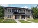Charming gray two-story home with stone accents, well-manicured lawn, and covered entryway at 15232 Detroit St, Thornton, CO 80602