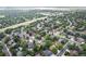 Scenic aerial view of community with tree-lined streets and nearby highway at 7830 W Friend Pl, Littleton, CO 80128