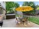 Beautiful backyard with patio, hot tub, umbrella, and dining table at 7830 W Friend Pl, Littleton, CO 80128