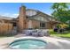 Backyard view featuring hot tub, patio, and outdoor seating at 7830 W Friend Pl, Littleton, CO 80128