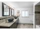 Modern bathroom with dual vessel sinks, granite countertops and a shower with tile accents at 7830 W Friend Pl, Littleton, CO 80128