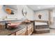 Bathroom featuring dual vessel sinks, granite countertops and a soaking tub with stone tile at 7830 W Friend Pl, Littleton, CO 80128