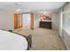 Spacious main bedroom featuring french doors, ceiling fan and a large window for natural light at 7830 W Friend Pl, Littleton, CO 80128