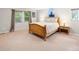 Bright bedroom with ample natural light, plush carpet, and a comfortable wooden bed frame at 7830 W Friend Pl, Littleton, CO 80128
