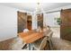 Elegant dining room with a modern chandelier and sliding barn doors to the kitchen at 7830 W Friend Pl, Littleton, CO 80128