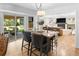 Open dining area with modern table and chairs, seamlessly connecting to the living room and outdoor patio at 7830 W Friend Pl, Littleton, CO 80128