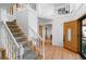 Grand foyer featuring a staircase, wooden front door, and hardwood floors at 7830 W Friend Pl, Littleton, CO 80128