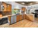 Modern kitchen with light wood cabinets, granite counters, stainless appliances, and a view to the backyard at 7830 W Friend Pl, Littleton, CO 80128