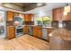 Updated kitchen with stainless steel appliances, granite countertops, and hardwood floors, ideal for modern living at 7830 W Friend Pl, Littleton, CO 80128