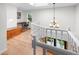 Bright upper landing with hardwood floors and a skylight; an office space is in the background at 7830 W Friend Pl, Littleton, CO 80128
