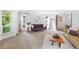 Bright living area featuring cozy seating, large windows, and seamless flow to the dining space at 7830 W Friend Pl, Littleton, CO 80128