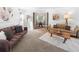 Cozy living room with plush sofas, warm lighting, and a view into the adjacent dining area at 7830 W Friend Pl, Littleton, CO 80128