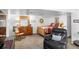 Basement living room featuring a sitting area with a rocking chair and a comfortable sleeping area at 7830 W Friend Pl, Littleton, CO 80128