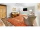 Basement living room with stylish seating, a vibrant rug, and a large screen TV for entertainment at 7830 W Friend Pl, Littleton, CO 80128