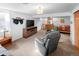 Basement living room with a large screen TV, reclining chairs, and a comfortable sleeping area at 7830 W Friend Pl, Littleton, CO 80128