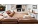 Inviting living room with a brick fireplace, mounted TV, and comfortable leather sofa at 7830 W Friend Pl, Littleton, CO 80128