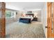 Spacious main bedroom featuring carpet, a ceiling fan, and a sitting area at 7830 W Friend Pl, Littleton, CO 80128