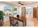 Bright office space with a wood ceiling, desk, chair, and windows offering outside views at 7830 W Friend Pl, Littleton, CO 80128
