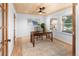 Well-lit home office with hardwood floors, wood ceiling, and a work desk by the windows at 7830 W Friend Pl, Littleton, CO 80128