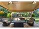 Covered patio features comfortable seating and ceiling fans at 7830 W Friend Pl, Littleton, CO 80128