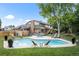 Backyard oasis featuring a sparkling pool, lush landscaping, patio seating, and a serene outdoor retreat at 7830 W Friend Pl, Littleton, CO 80128