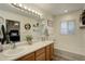 Bright bathroom featuring double sinks, a bathtub, and modern lighting fixtures at 637 Millet Cir, Brighton, CO 80601