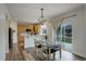 Bright dining room with a decorative light fixture and sliding glass doors that lead to the backyard at 637 Millet Cir, Brighton, CO 80601