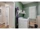 This laundry room features shelving, a door to outside, and washer at 637 Millet Cir, Brighton, CO 80601