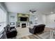 Open-concept living room with a fireplace, large windows, and a seamless transition to the dining area at 637 Millet Cir, Brighton, CO 80601