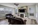 Comfortable living room features a cozy fireplace, a television, and large windows that bring in natural light at 637 Millet Cir, Brighton, CO 80601