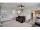 Bright living room with hardwood floors, a ceiling fan, and a view of the staircase and open doorway at 637 Millet Cir, Brighton, CO 80601