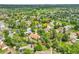 Aerial view of residential neighborhood featuring mature trees, well-kept homes, and community amenities at 3224 S Dudley St, Lakewood, CO 80227