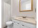 Bright bathroom with white vanity, marble countertop, and shower with decorative curtain at 3224 S Dudley St, Lakewood, CO 80227