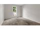 Cozy bedroom with neutral carpeting, a bright window, and ample natural light at 3224 S Dudley St, Lakewood, CO 80227