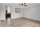Bright living room with wood-look flooring and ceiling fan, ready for customization and comfort at 3224 S Dudley St, Lakewood, CO 80227