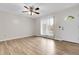 Inviting living room with wood-look floors, a large window, and a ceiling fan at 3224 S Dudley St, Lakewood, CO 80227