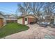 Beautiful backyard showcases a stone patio, green grass, and convenient access to the brick garage at 586 S Corona St, Denver, CO 80209