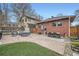 Spacious backyard offers stone patio with outdoor seating, a dining table, and lush green lawn at 586 S Corona St, Denver, CO 80209